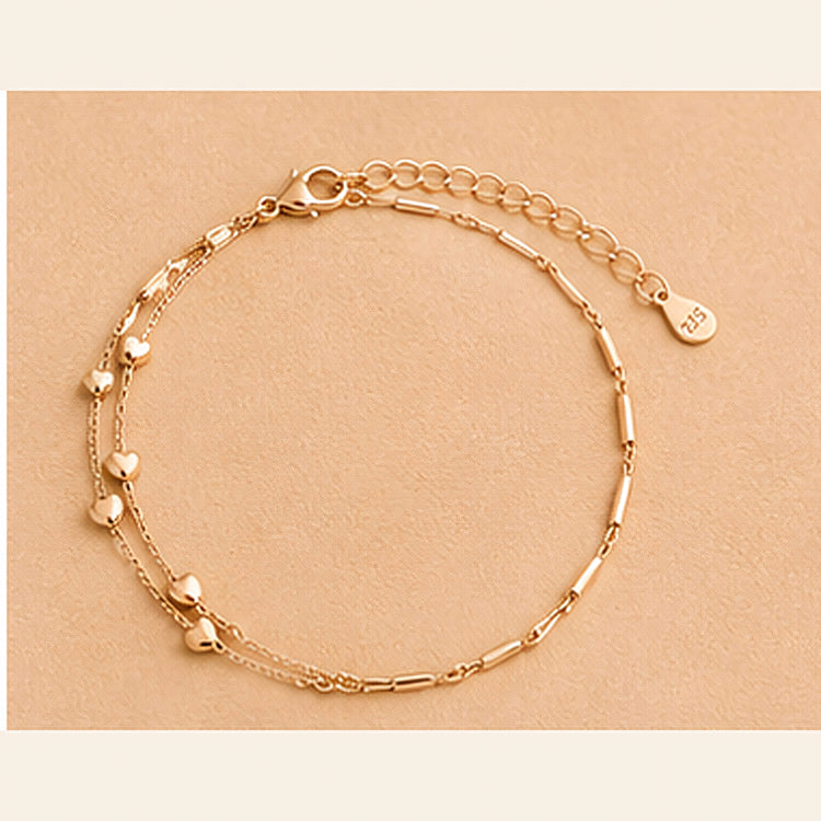 Double-layer rose gold tone bracelet with heart motifs