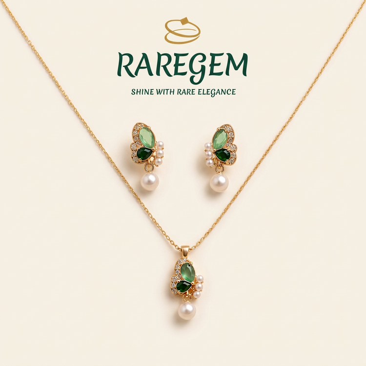 Emerald butterfly pearl pendant and earrings set on ivory with RAREGEM logo