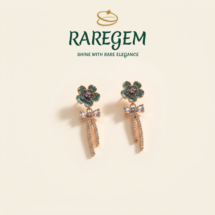 Teal flower tassel earrings on ivory with RAREGEM logo